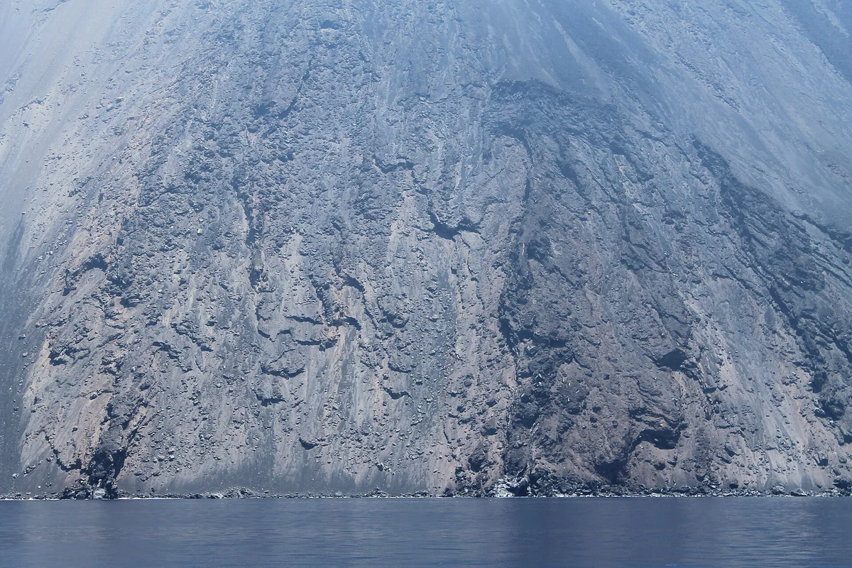 The steep green north coast of Stromboli island above the sea, Aeolian Islands, Italy