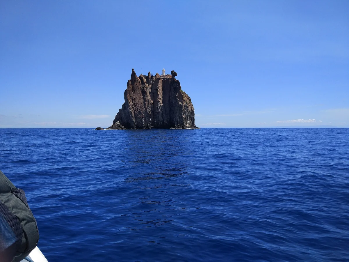 Strombolicchio rock with its lighthouse seen from the north-east of Stromboli, Aeolian Islands, Italy